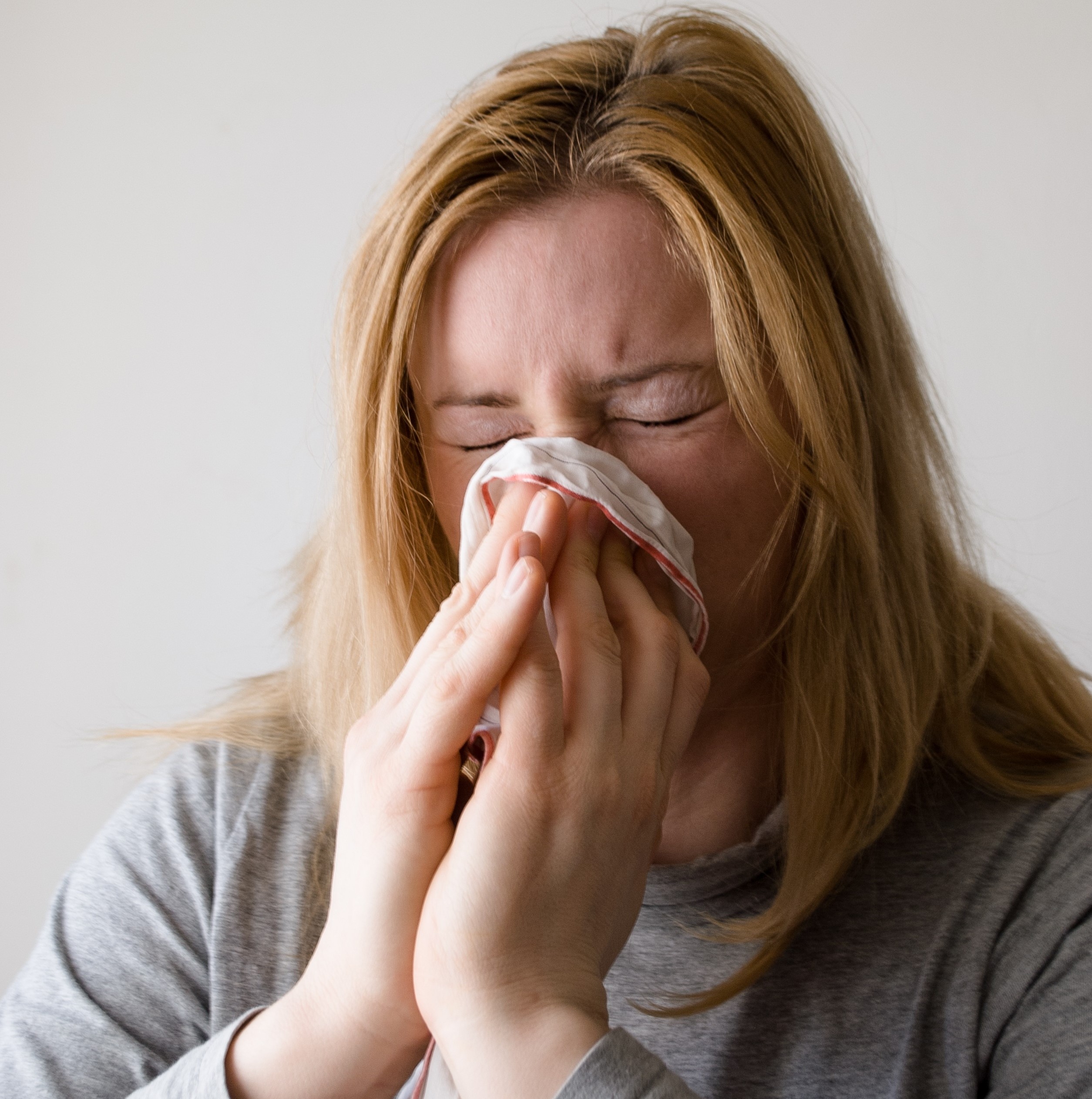 Woman blowing nose