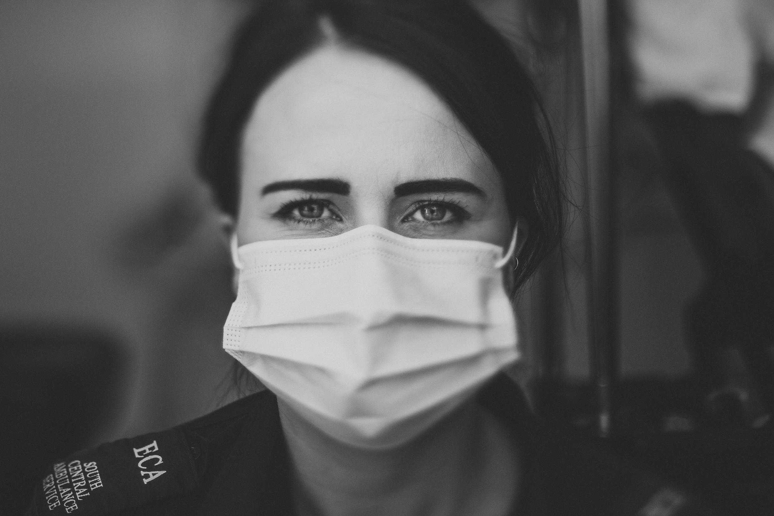 Female paramedic with mask looking directly a camera