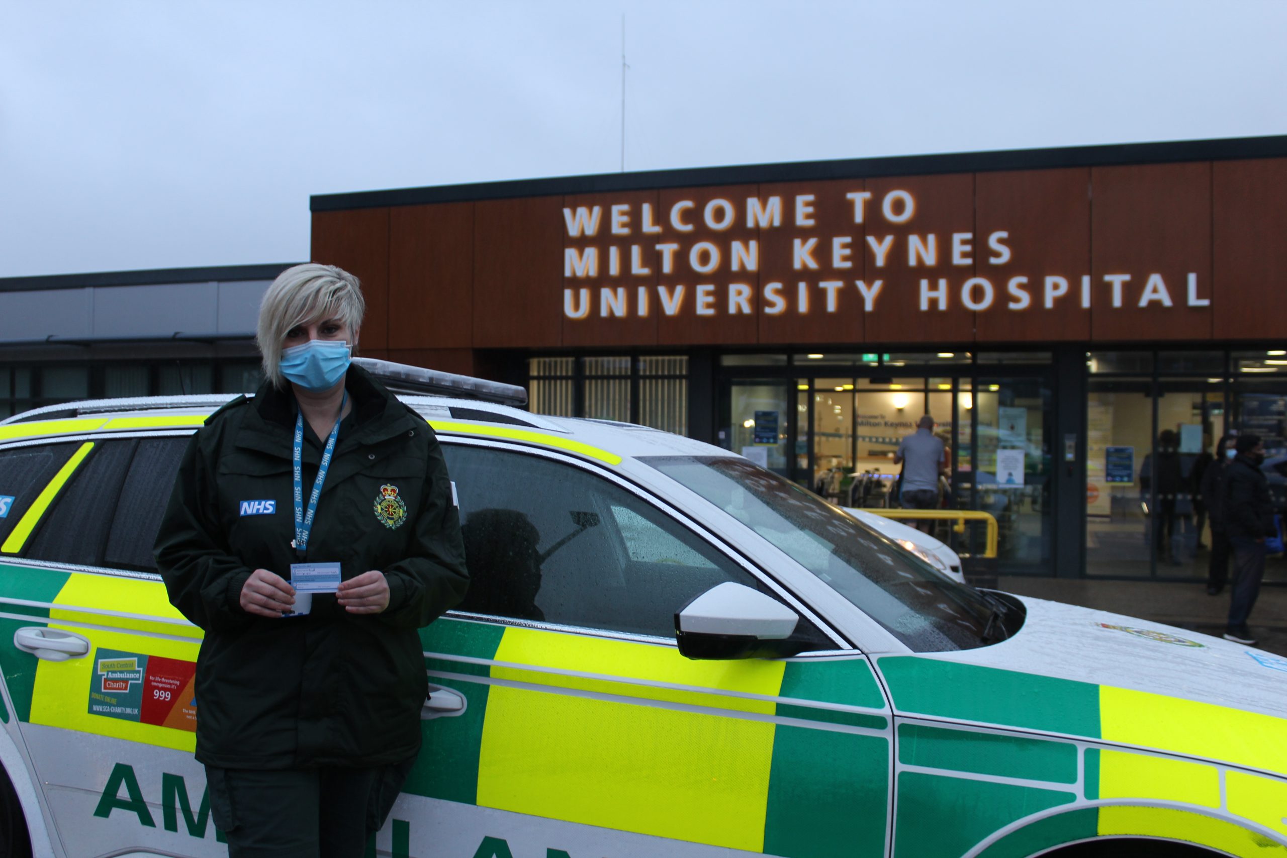 Person standing in front of emergency response car