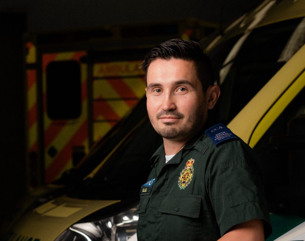 Ellis standing in front of ambulances
