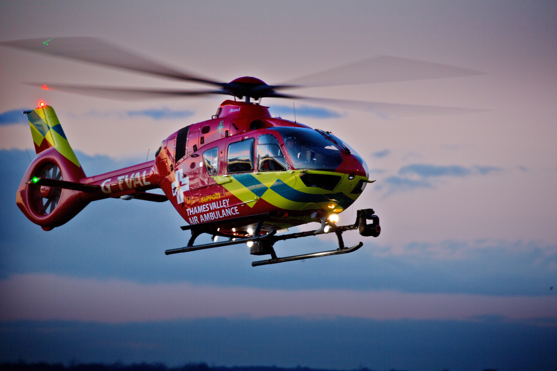 Thames Valley Air Ambulance flying at dusk