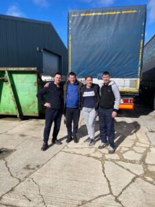 People standing in front of HGV lorries