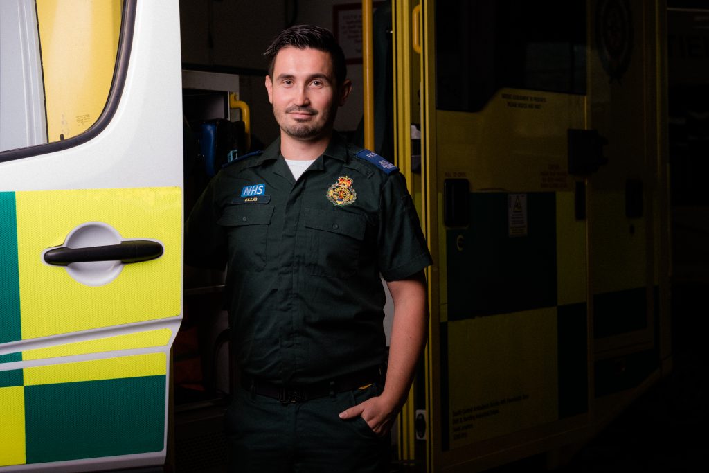 Ellis standing next to an ambulance