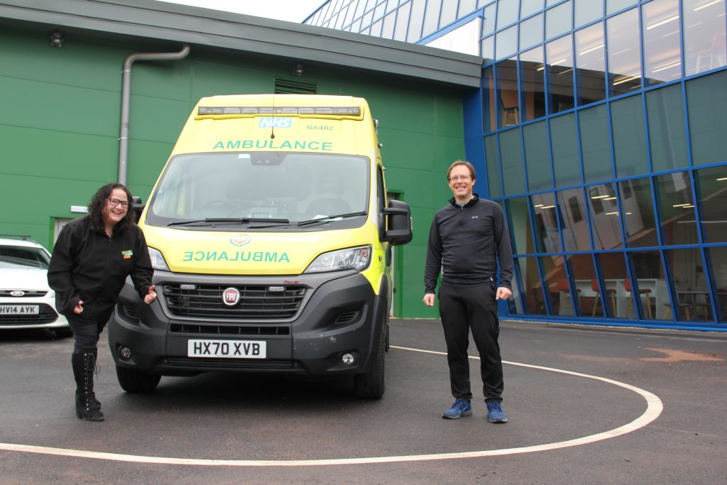 Laura and Will standing next to an ambulance