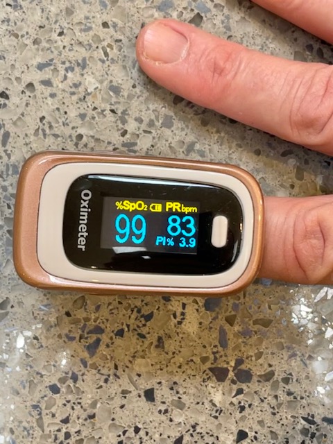 Pulse oximeter showing display on patient's finger
