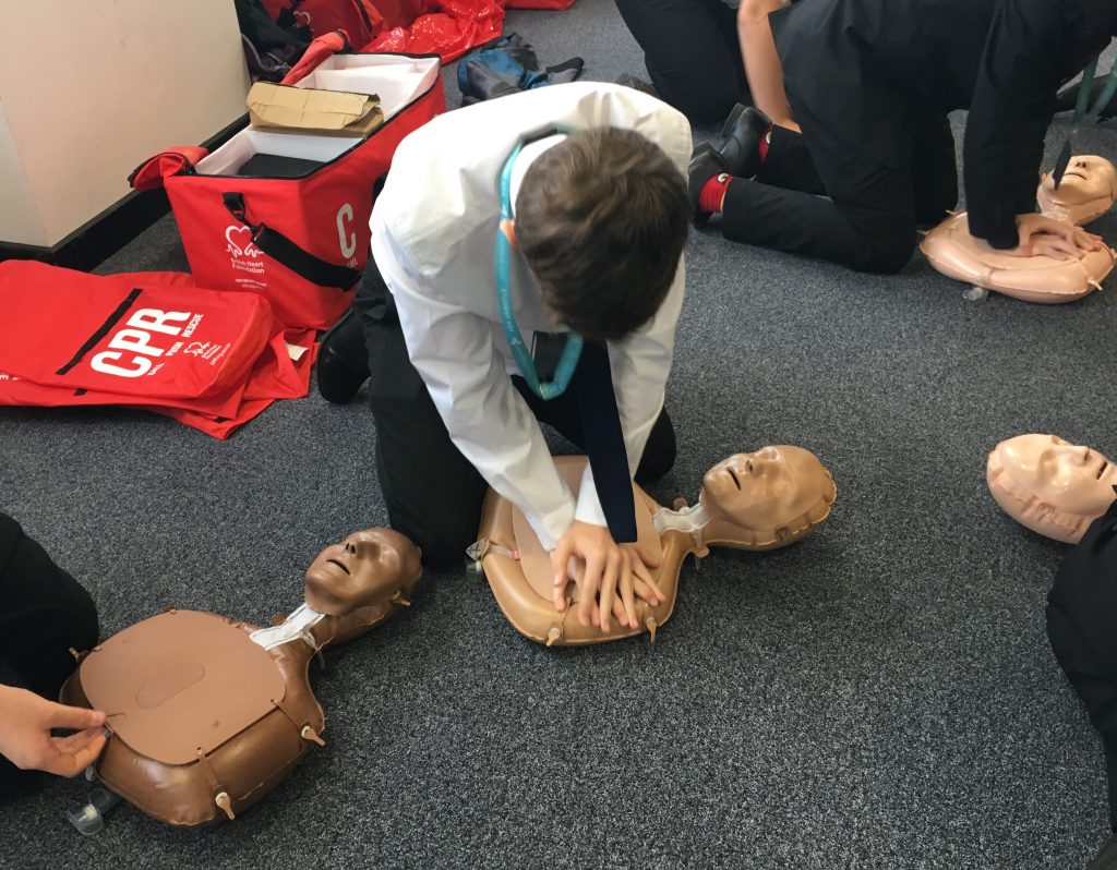 Student performing CPR at a previous Restart a Heart school event