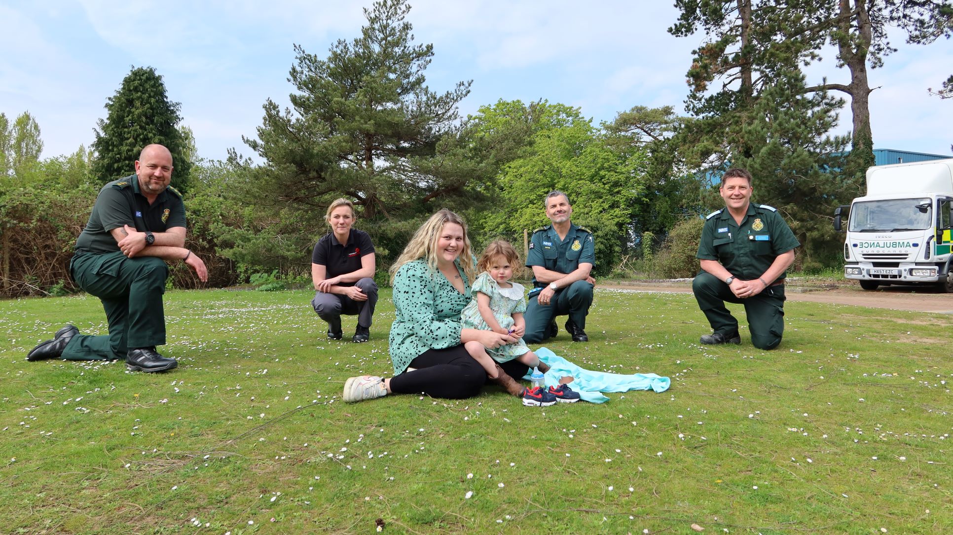 Shaun Emma Dave and Lee kneeling behind Kelly and Rumi Siret Emergency services personnel with Kelly and Rumi Siret