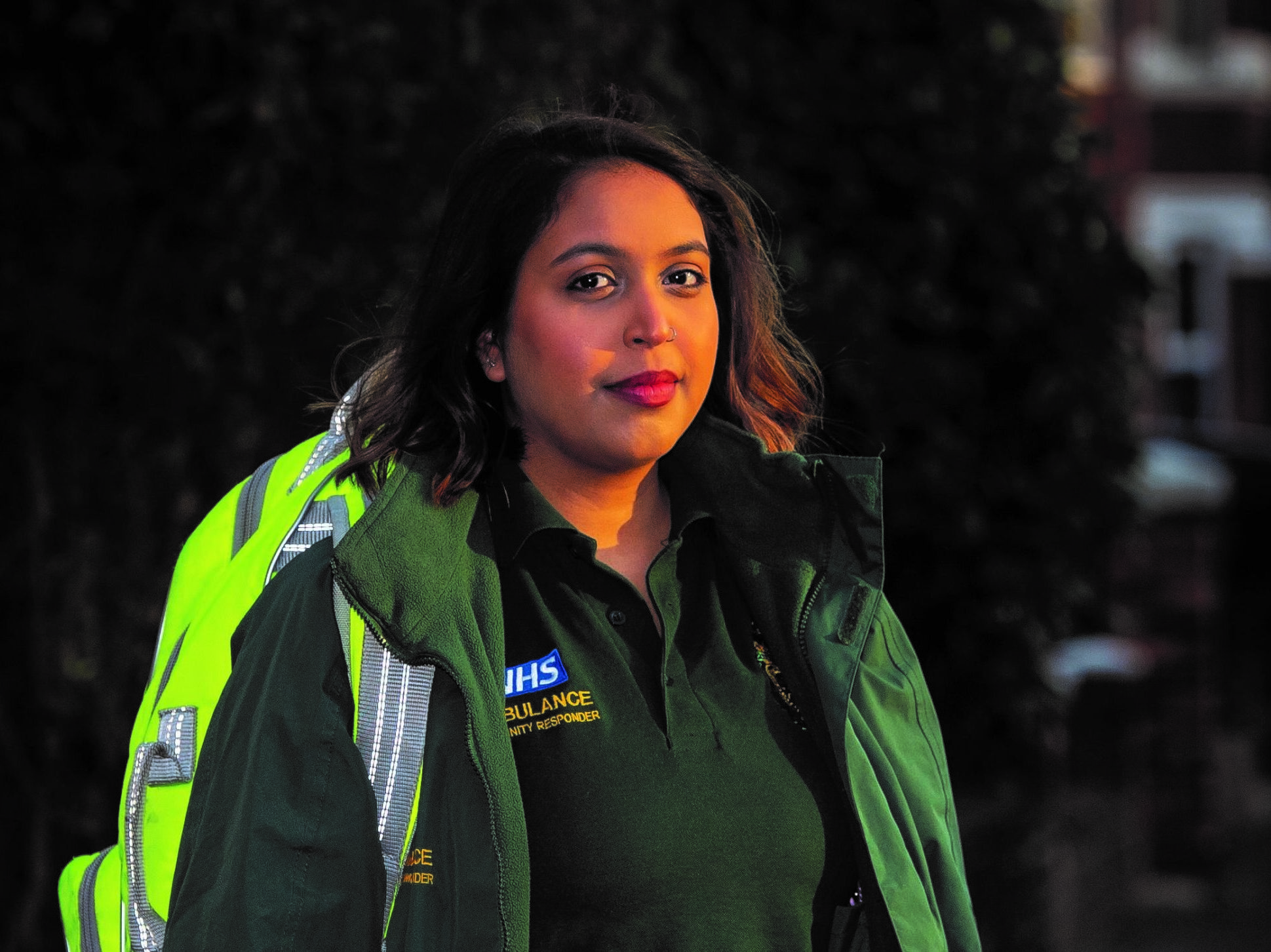 Community First Responder in uniform standing outside