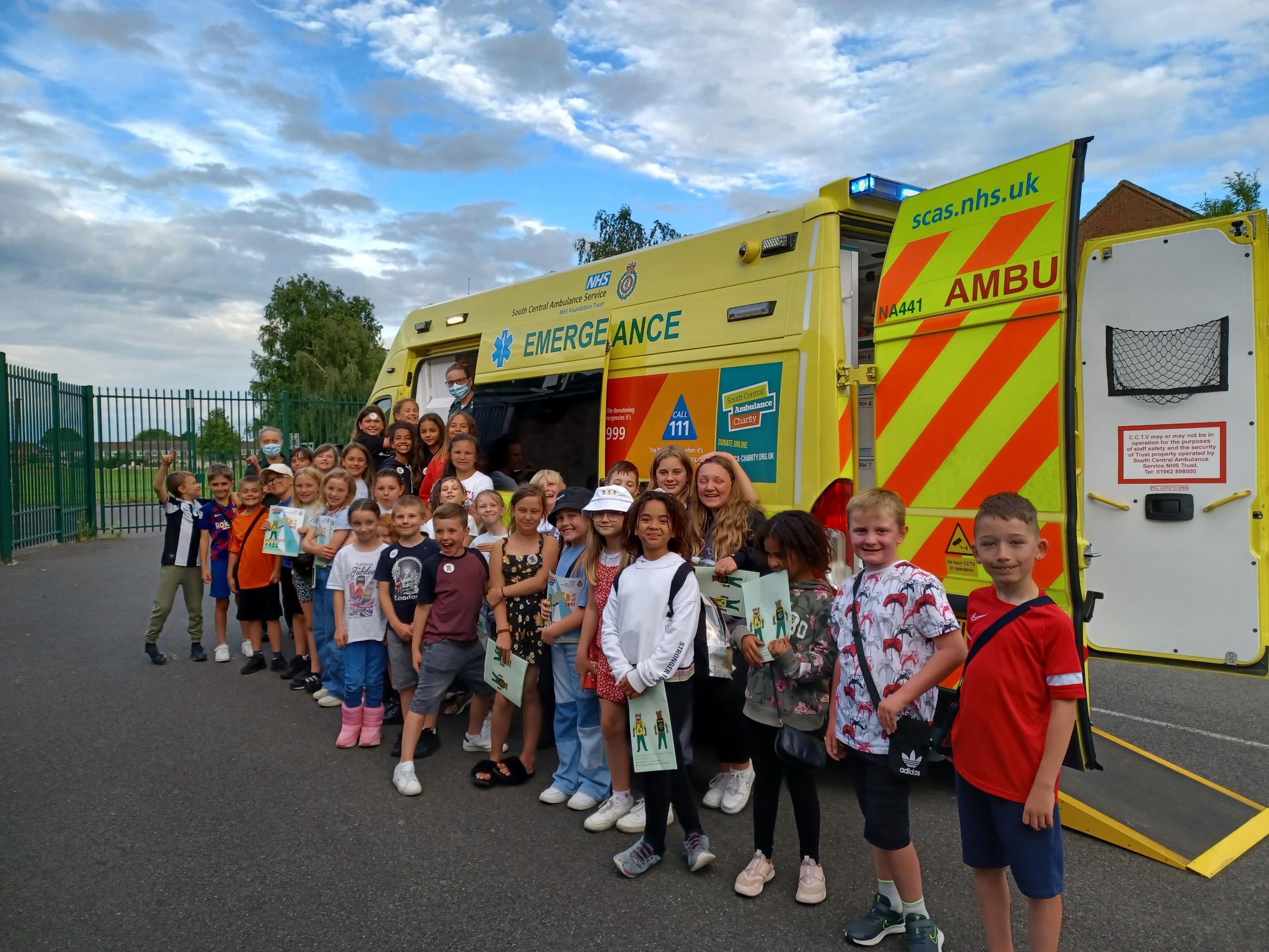 Image of SCAS staff visiting children at a youth club with an ambulance