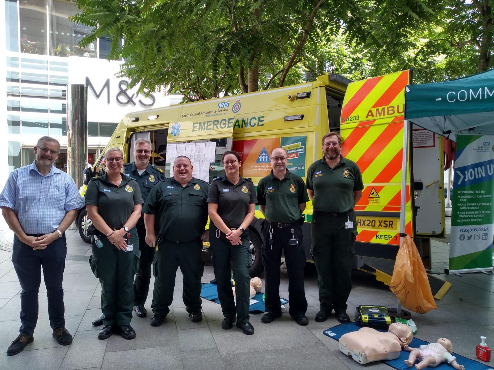 SCAS colleagues standing together in front of the vehicle