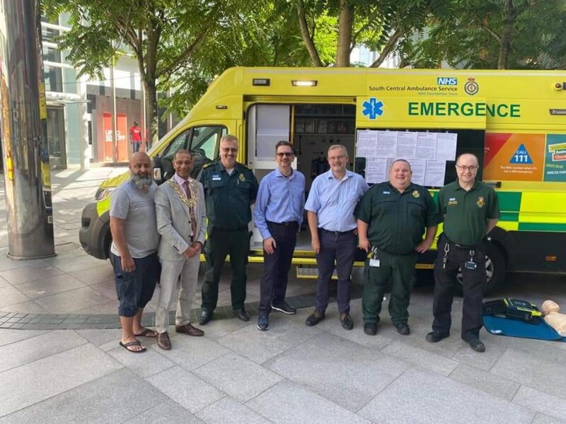 SCAS colleagues and public standing in front of a vehicle