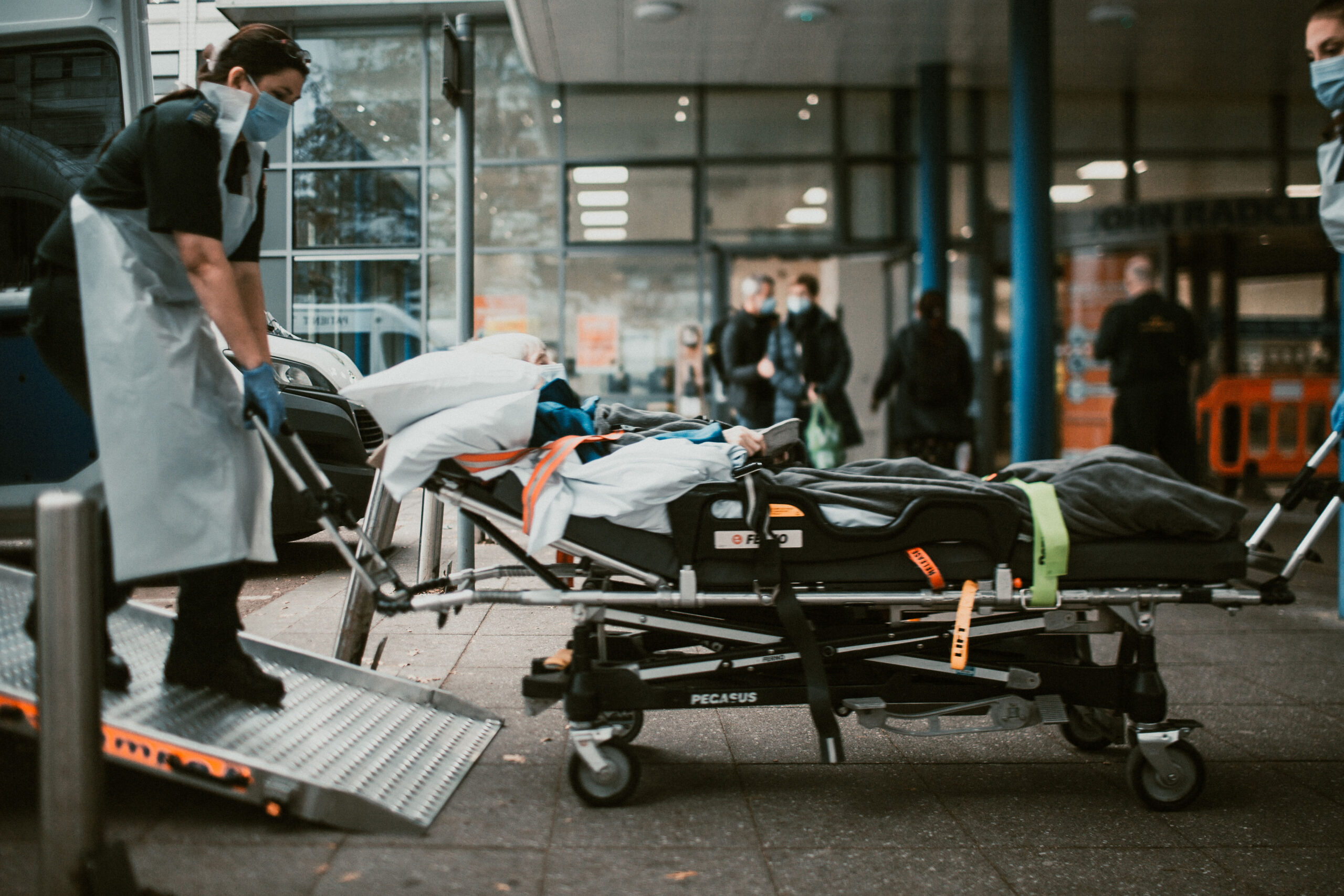 Ambulance care assistants moving patient