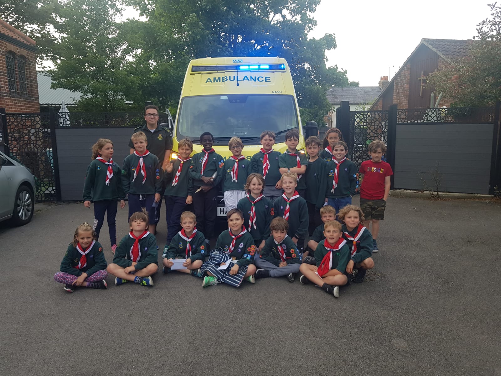 Scout and Cub Group in front of an ambulance vehicle