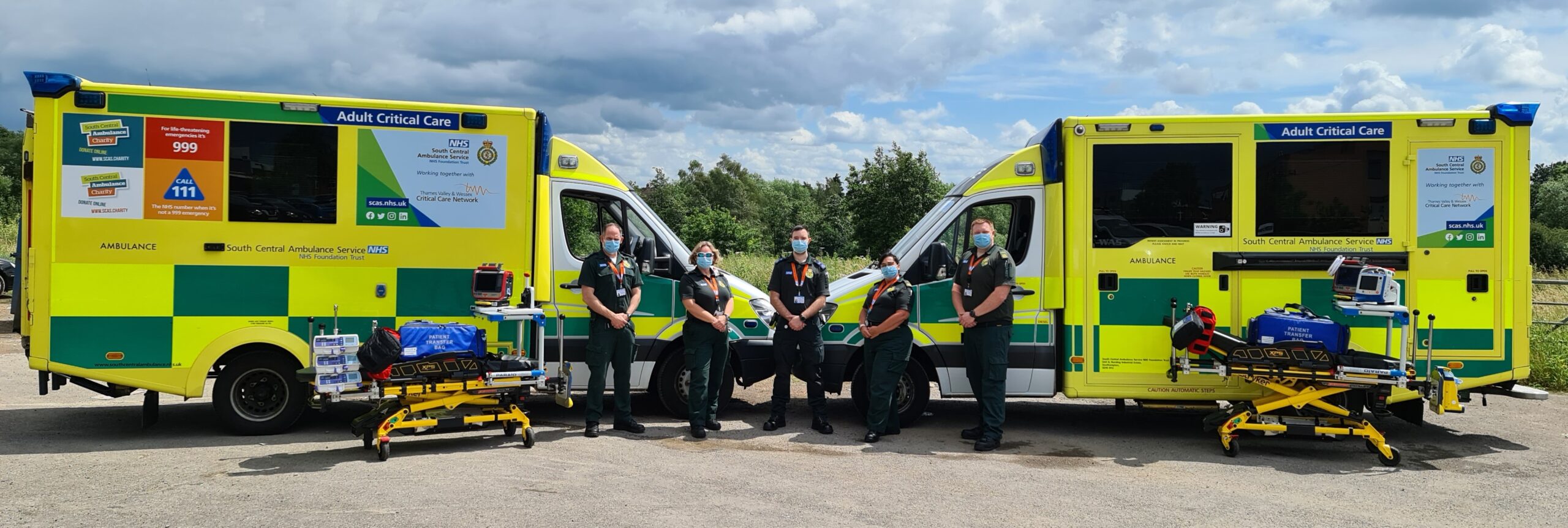 Adult Critical Care Transfer Team standing outside ambulance