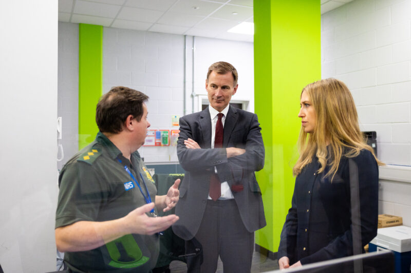 The chancellor and chief secretary standing to talk to a paramedic