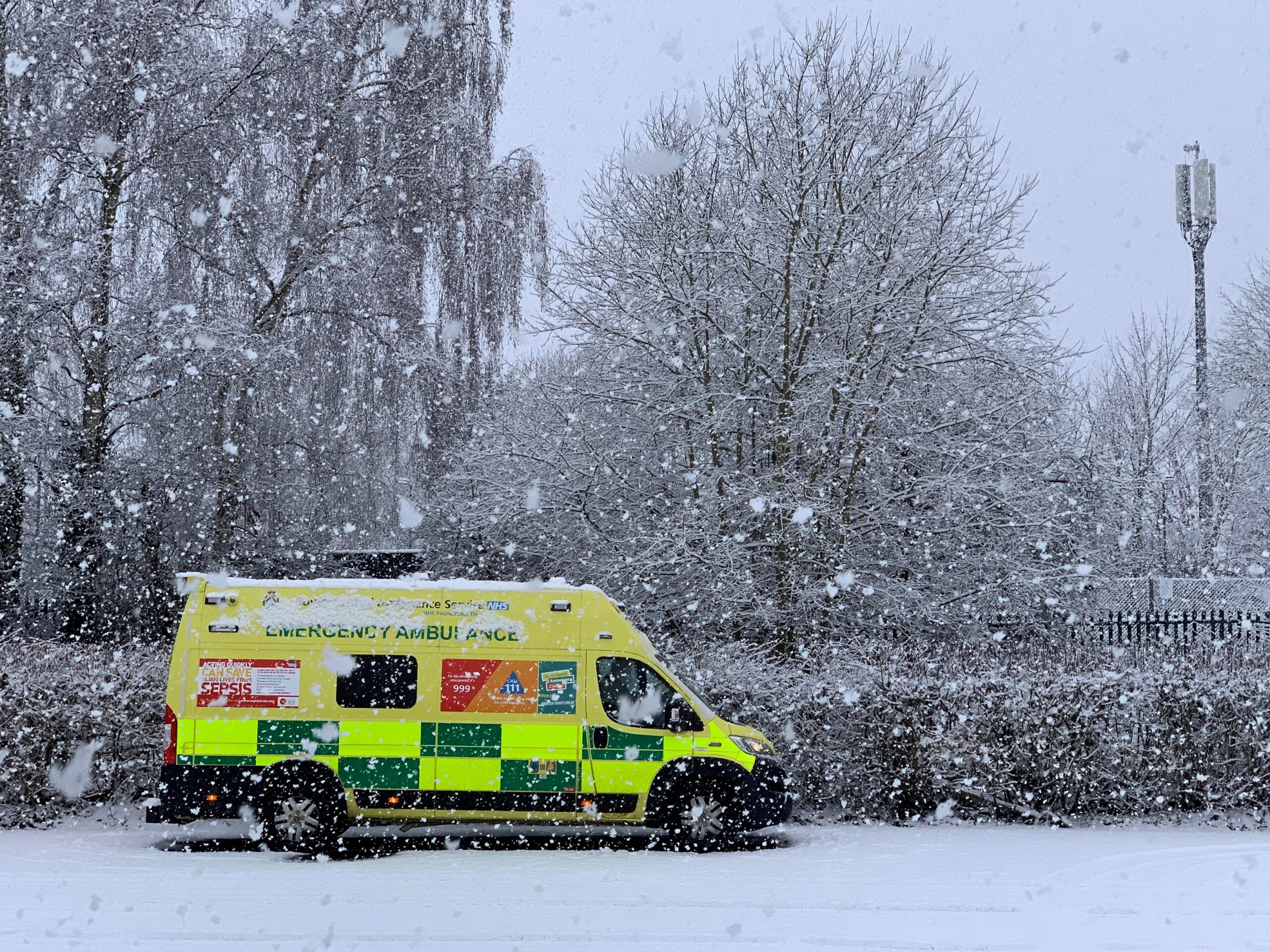 Emergency ambulance parked in winter snow scene