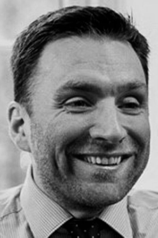 Black and white portrait photo of Craig Ellis