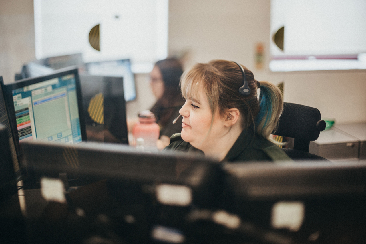 Call taker in ambulance uniform in the CCC