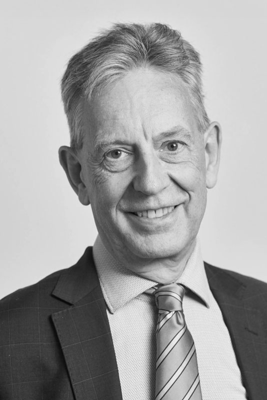 Gary Ford NED, wearing a suit and tie