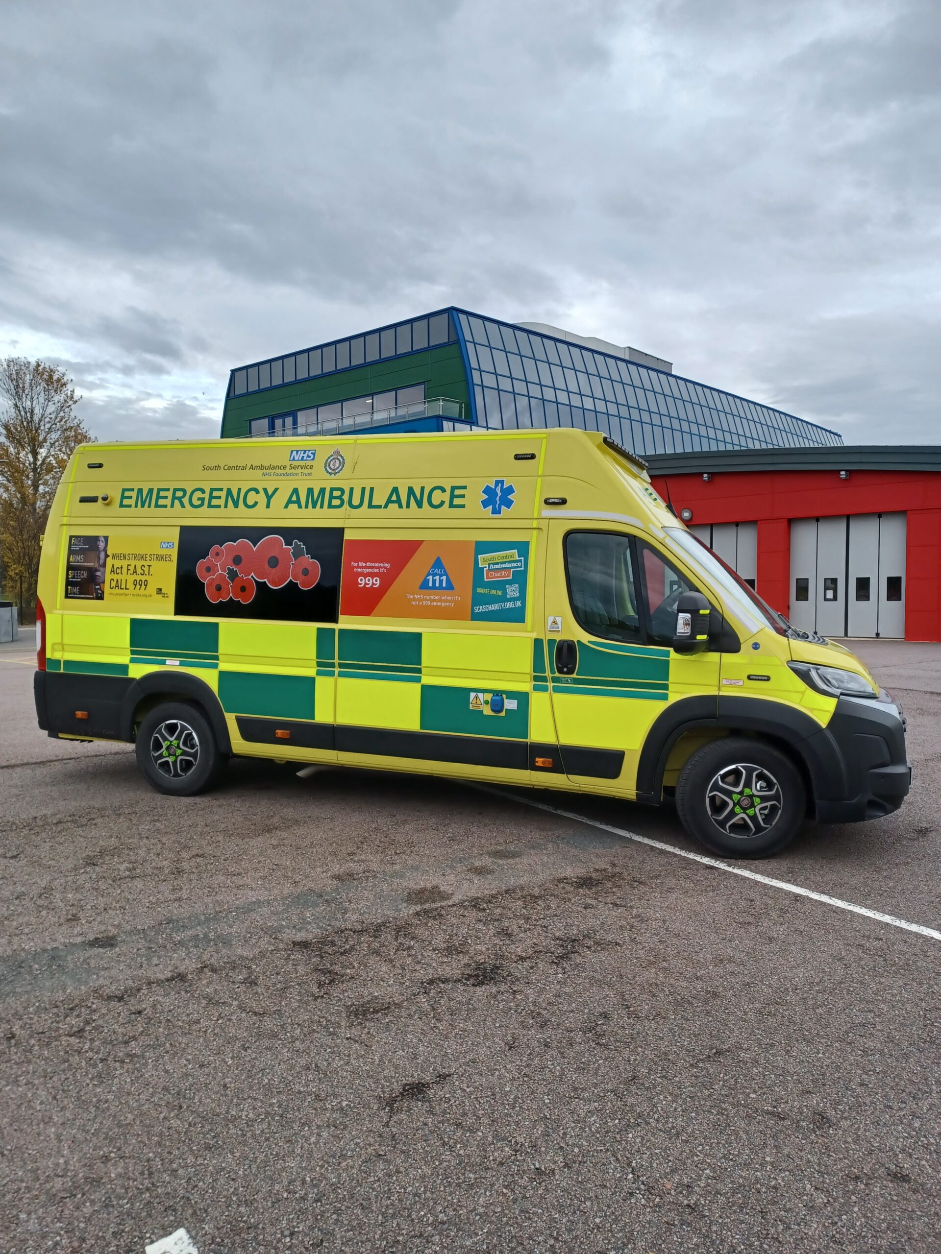 An ambulance with poppy branding parked in front of the Blue Light Hub in Milton Keynes.