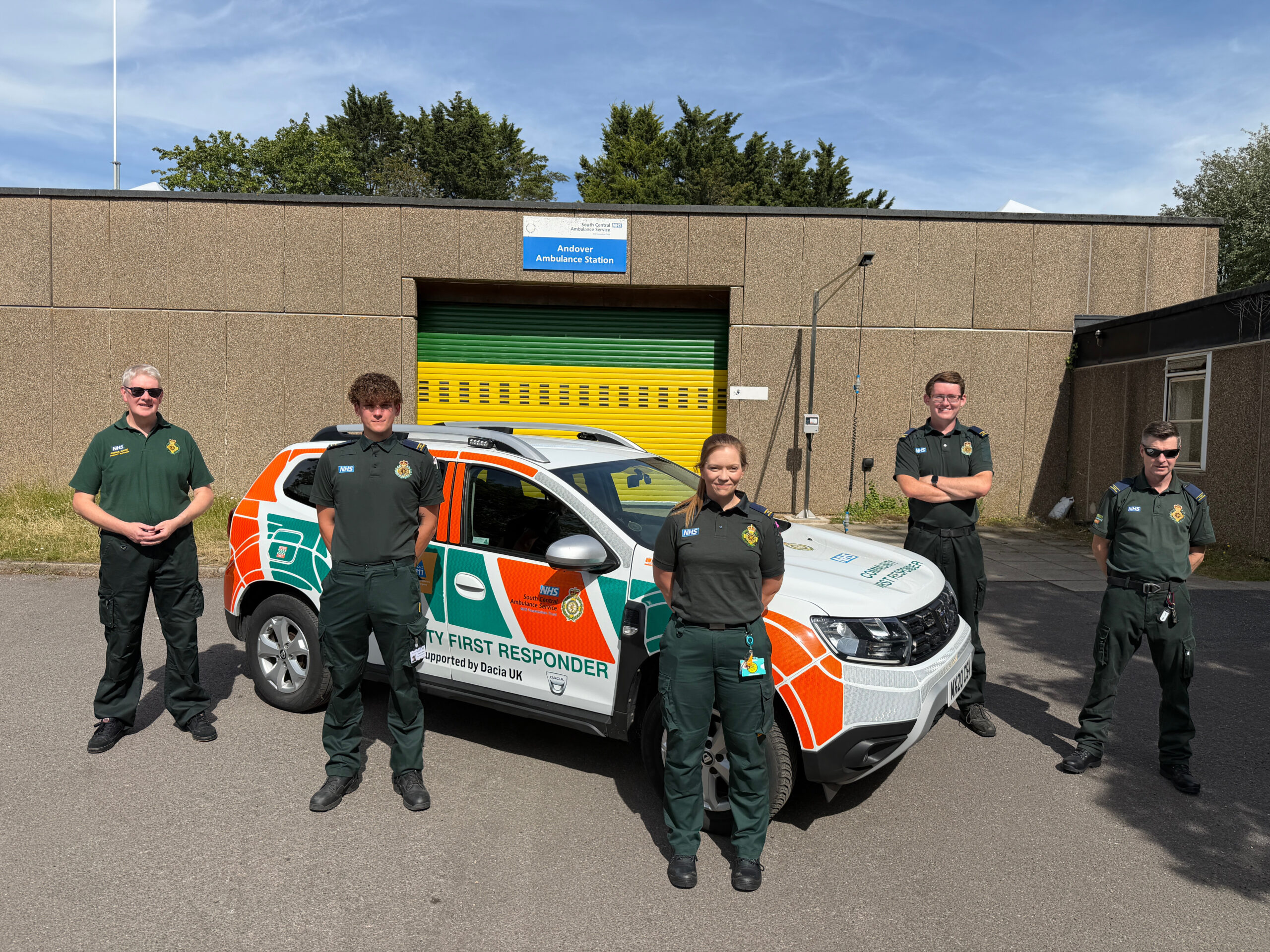 Andover CFRs with new DRV A group of community first responders in ambulance green uniforms stand around a specially branded car parked outside Andover Ambulance Station