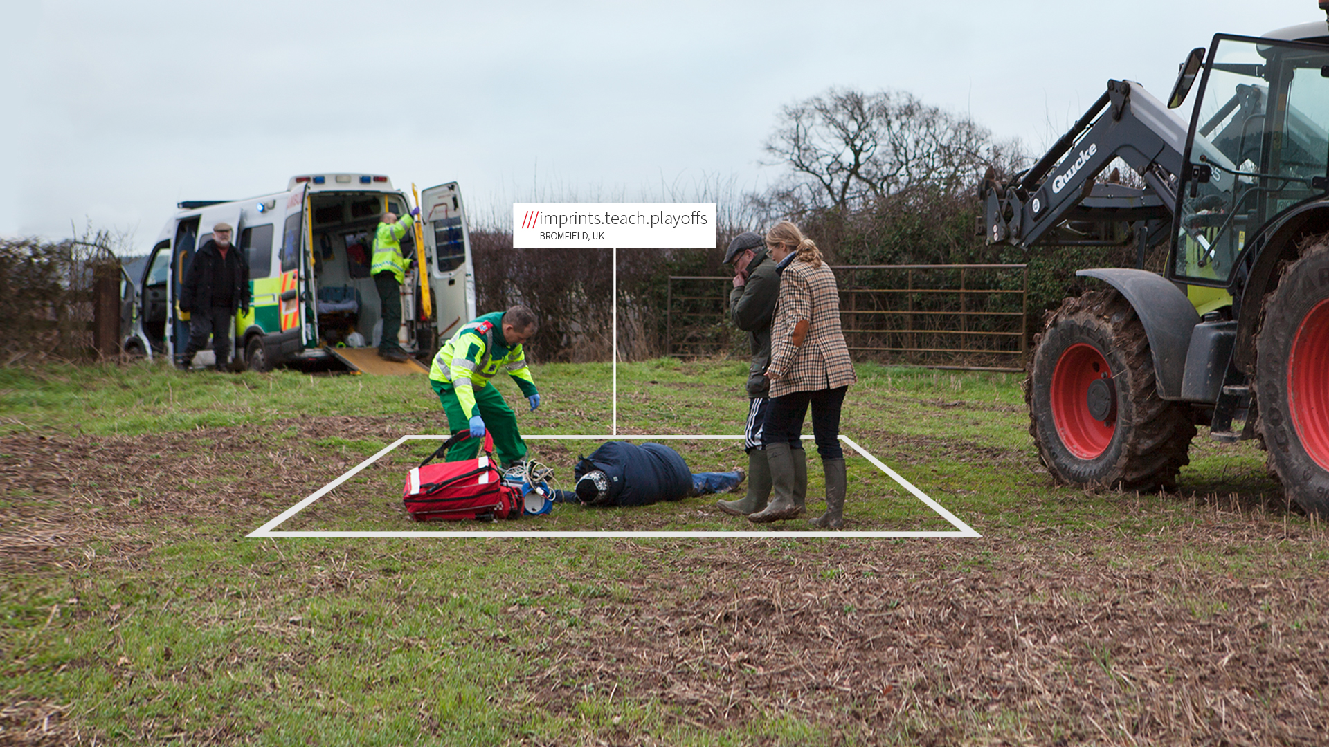 Health and Safety An ambulance crew arrive at a farm location where a man is lying on the floor next to a tractor. A white box around the man with the words imprints.teach.playoffs shows his exact location as detailed by the what3words app