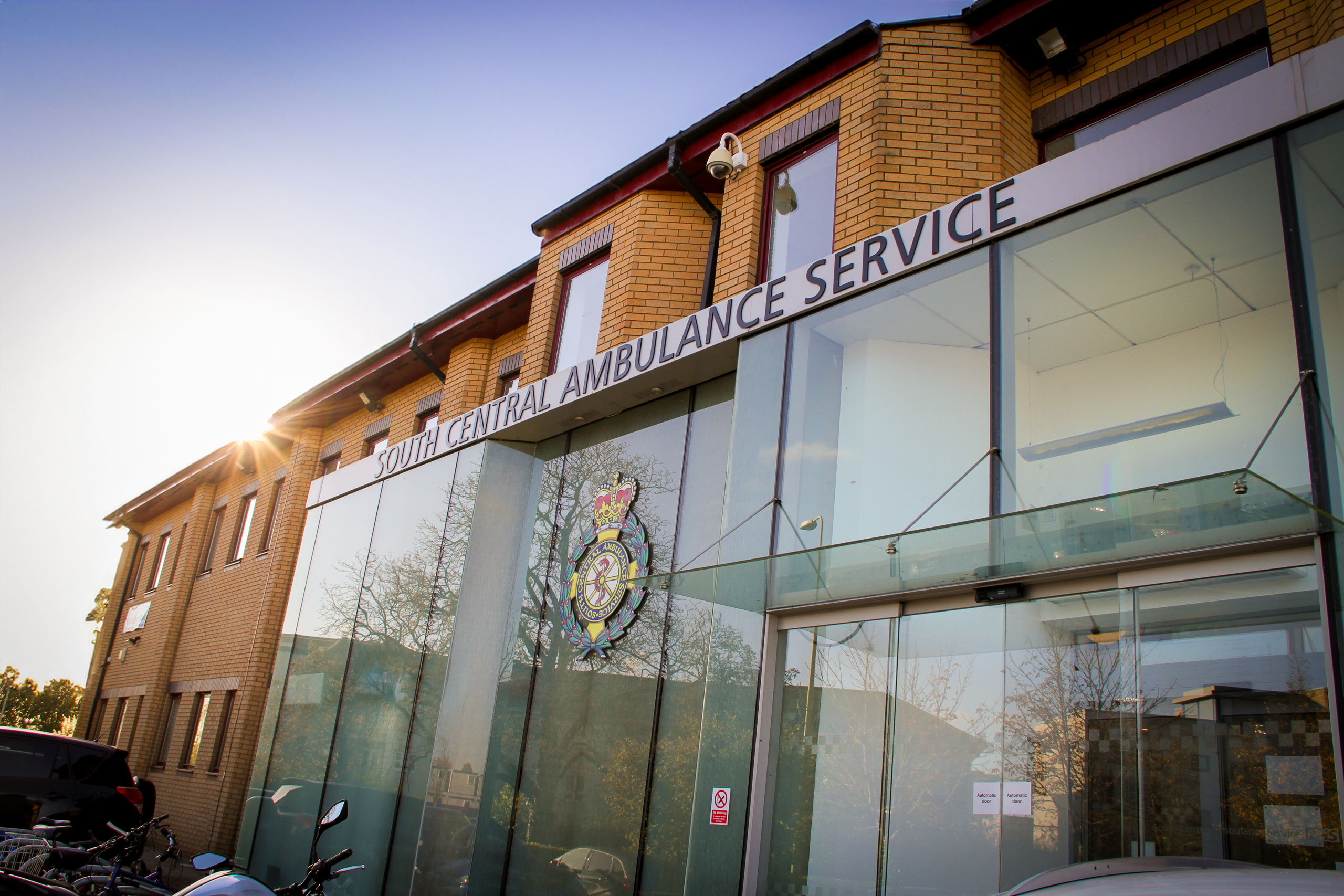 The exterior of an office building with a sign that reads South Central Ambulance Service over the entrance