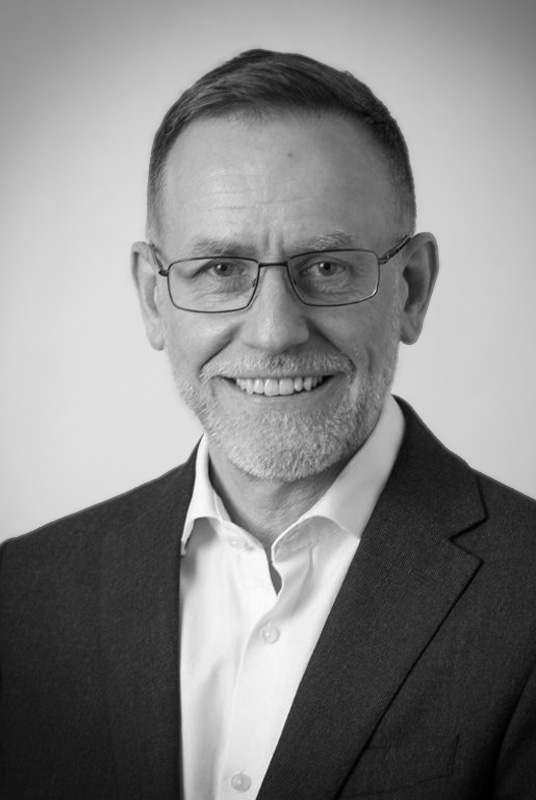 Jon Bell Interim Chief Finance Officer portrait in black and white